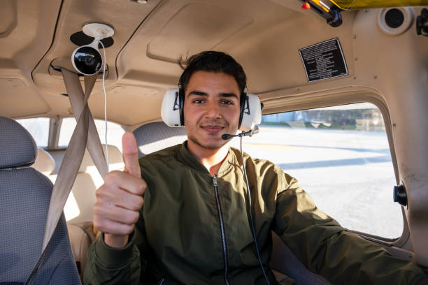 young pilot candidate receiving flight training meets with the tower - avionics flying training cockpit fotografías e imágenes de stock