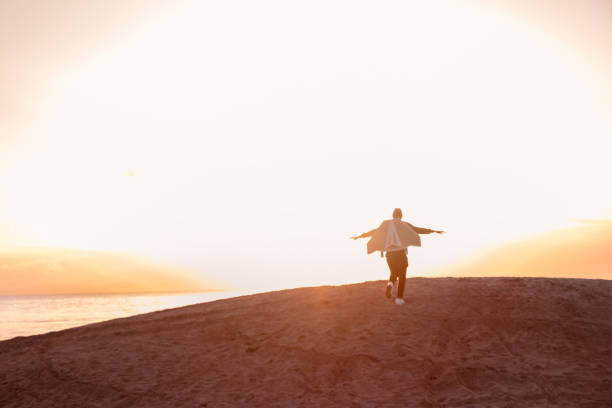 Young man flies with jetPack chasing his dreams on the beach