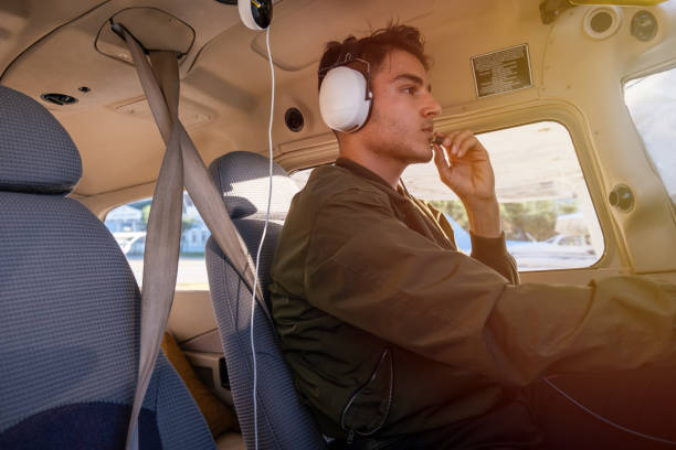 young pilot candidate receiving flight training meets with the tower - avionics flying training cockpit fotografías e imágenes de stock