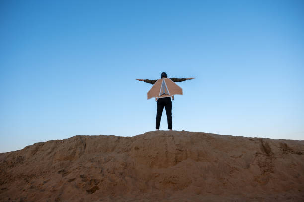 istock Young man flies with jetPack chasing his dreams on the beach 2074891530