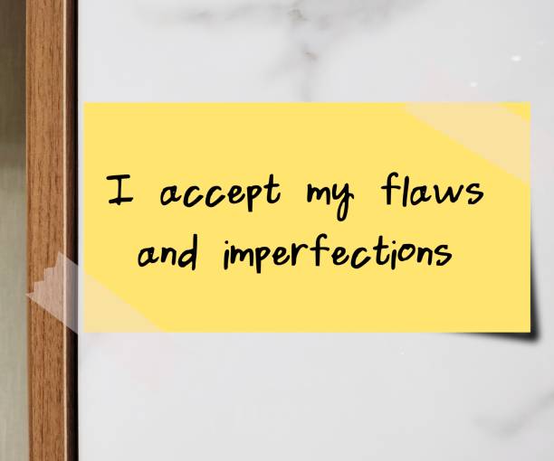 Stick note on wall with handwritten message I ACCEPT MY FLAWS AND IMPERFECTS , positive self talk of self love , self compassion, self acceptance and self validation by embracing imperfection