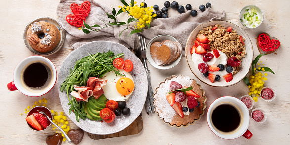 Healthy breakfast with oatmeal, berries, egg, bacon and a cup of coffee. Good morning. Top view, panorama