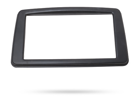 Decorative frame of a luxury car radio made of black plastic on a white isolated background