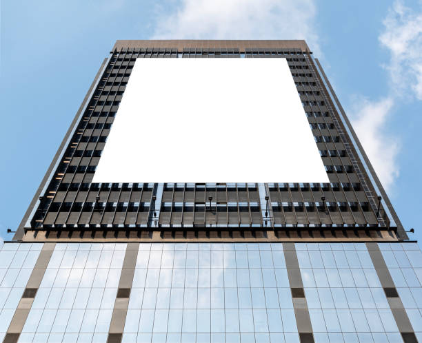 istock Mock up white vertical large LED display billboard on tower building with blue sky background .clipping path for mockup 2074959258