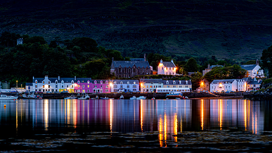 A scenic view of Portree Harbour, Isle of Skye at night