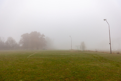 This picture shows the Landscape of Brandenburg, Germany, on October 2011. Abandoned Soccer field in the countryside near Berlin. Foggy mood