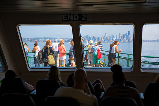 Bainbridge Island, Washington - August 13th 2015, Tourists enjoying views on the deck of Washington State Ferry between Bainbridge island and Seattle Washington.
