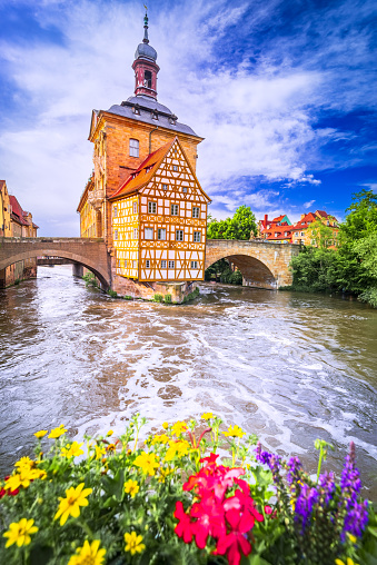 Bamberg, Germany. Charming small city of Franconia with amazing colored sky, Regnitz River water reflection.