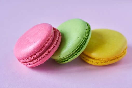 Colorful macaroons on a pink background. Close-up.