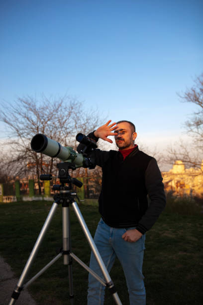 istock Amateur astronomer observing Sun eclipse and Sun with a telescope and special solar filter. 2075075499