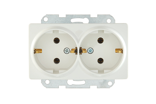Multiple plugs in wall electrical outlet is dangerous overload, close-up with copy space