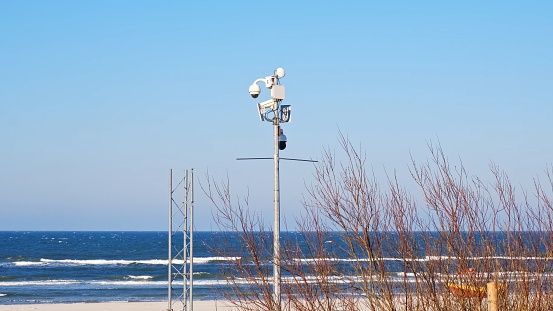 Public Seashore Beach Equipped with Coast Guard and Lifeguard Surveillance Cameras Installed on Metal Post