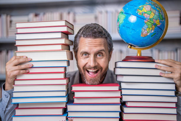 istock bookworm in school library. education and knowledge. man teacher in class. school education. man with school book. school literature education. nerd man in classroom. Unleash the power of reading 2075090403