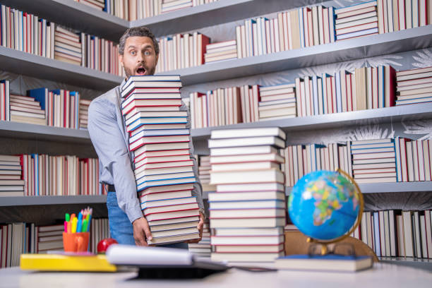istock get knowledge from book. man get university education. school education with man teacher. education and knowledge. back to school. teachers day. teachers education in school. knowledge day. homework 2075090952
