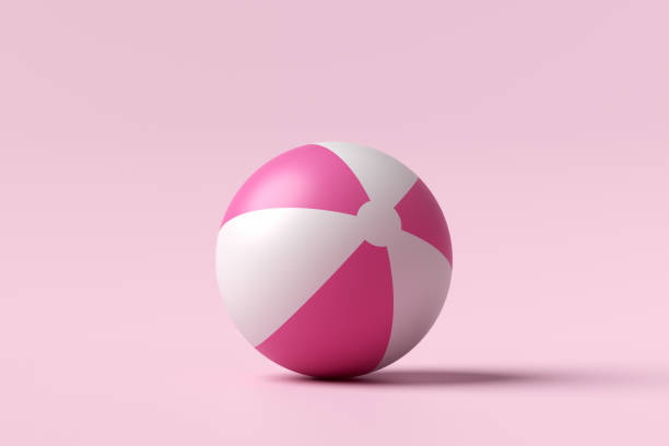 Inflatable beach ball on pink background. Summer holiday, vacation concept. 3D render.