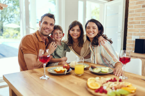 istock Happy family enjoying during a meal at dining table. 2075105372