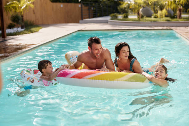 istock Happy family having fun during summer day in the pool. 2075106447