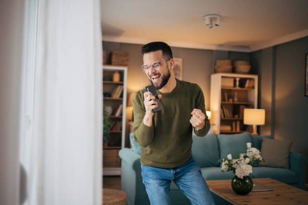 istock A man dances and sings at home. 2075110199