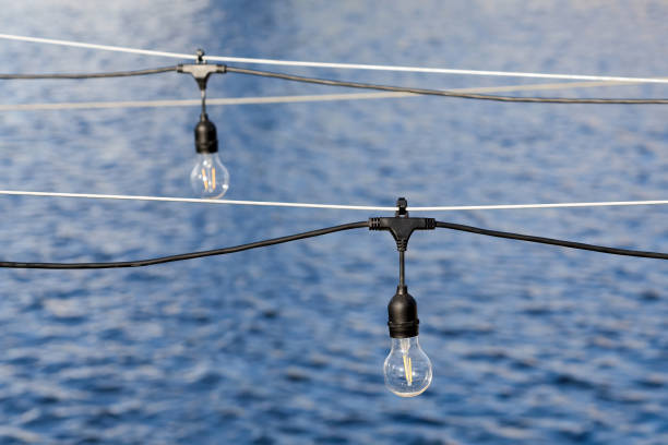 istock A garland of light bulbs over the water. 2075113486