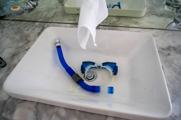 istock Blue snorkel with goggles placed in a white sink. 2075115098