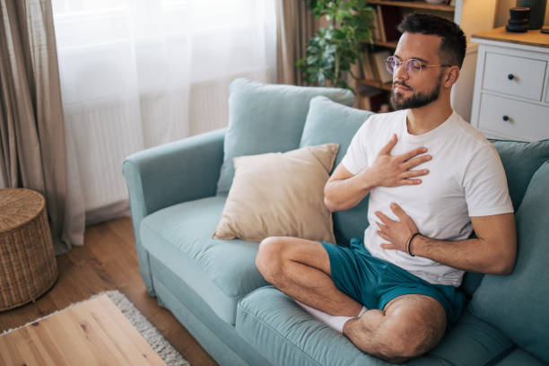 istock A man sits at home and practices yoga. 2075115123