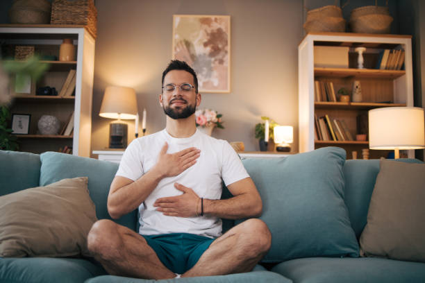 istock A man sits at home and practices yoga. 2075115129