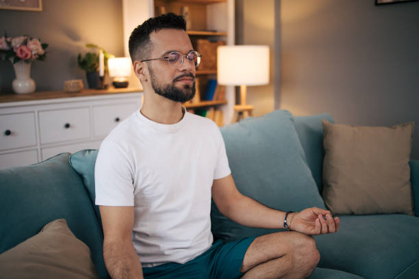 istock A man practices yoga at home. 2075115242