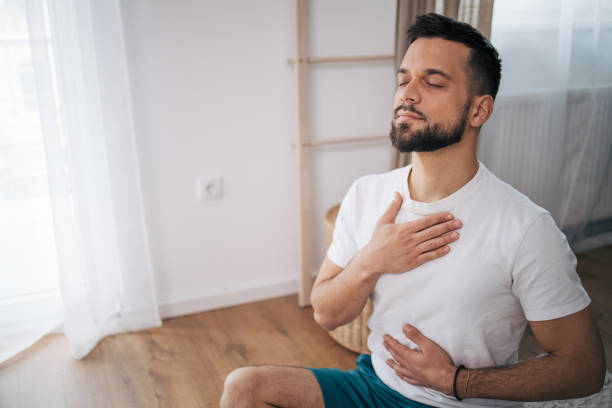 istock A man practices yoga at home. 2075115520