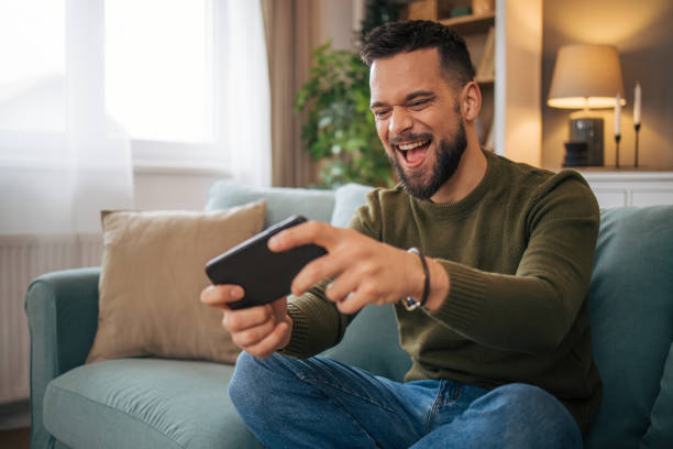 istock A man plays games on a smartphone. 2075115667