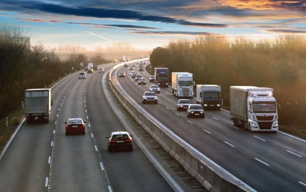 istock Transportation trucks in high speed driving on a highway through rural landscape. Freight scene on the motorway 2075115697
