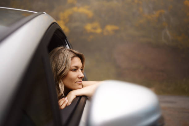 istock Relaxed woman day dreaming through a car window. 2075115710
