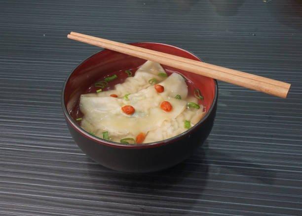 istock handmade deep fried and boiled pork meat dumpling wanton soup in plate on dark grey wood table asian dim sum halal food restaurant cuisine banquet menu for cafe 2075127714