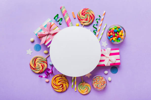 istock Flat lay holiday composition. Paper blank, lollipop, birthday decorations on Colored background. Top view, copy space for text 2075136496