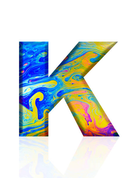 istock Isolated shot of three-dimensional rainbow colored soap bubble alphabet letter K on white background 2075141973