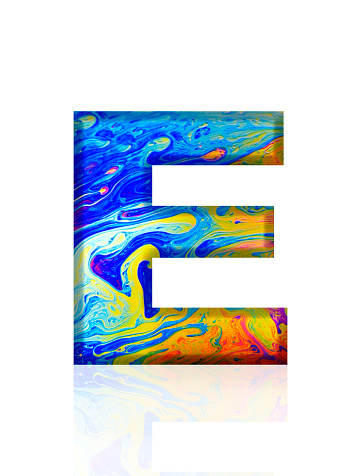 Extreme close-up of three-dimensional rainbow colored soap bubble alphabet letter E on white background.