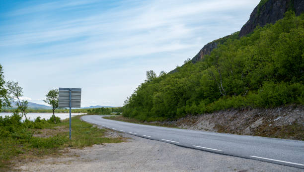istock Asphalt road on the coast with small trees and hills 2075154772