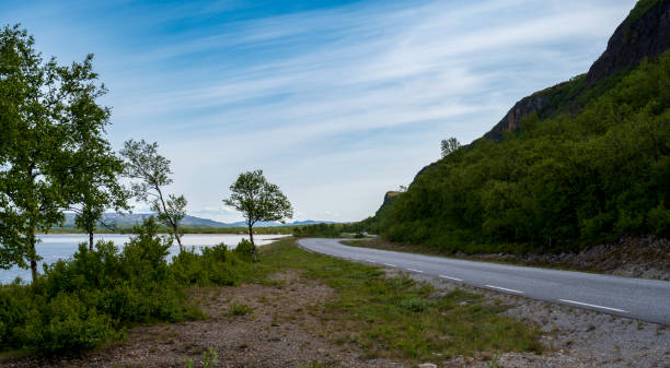 istock Asphalt road on the coast with small trees and hills 2075155292