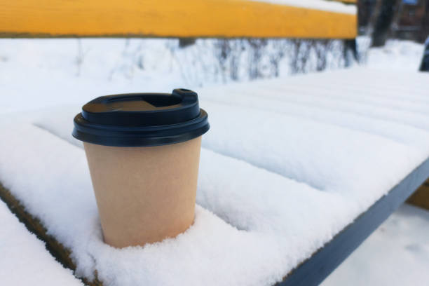 istock lone disposable coffee cup on snowy bench 2075161474