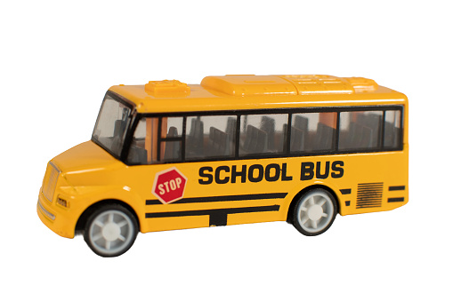 A yellow school bus with a red stop sign on the front. The bus is parked on a white background