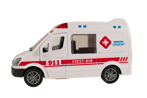 A white ambulance with red cross on the side and the words First Aid on the door