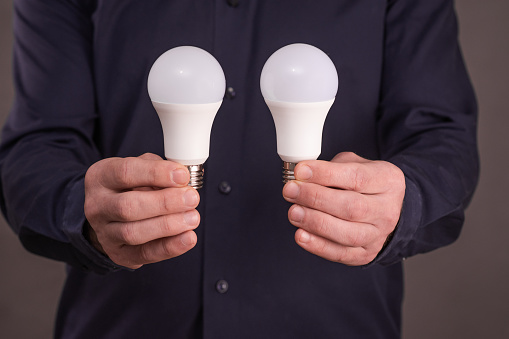 two LED lamps in the hands of a man