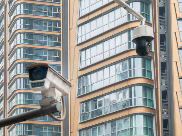 modern cctv camera hanging over modern residential building.