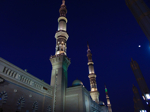 A low angle shot of the minarets of Al-Masjid An-Nabawi and its stunning lightings.