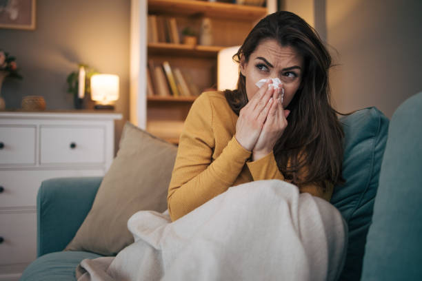 istock Sick woman sitting on sofa at home. 2075187810