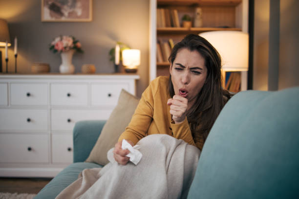 istock Sick woman sitting on sofa at home. 2075188426