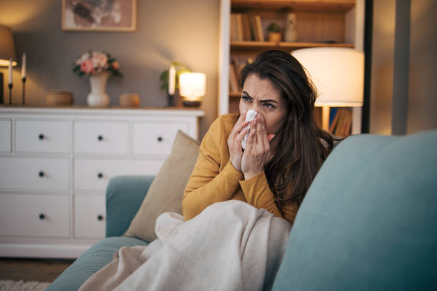 istock Sick woman sitting on sofa at home. 2075189597