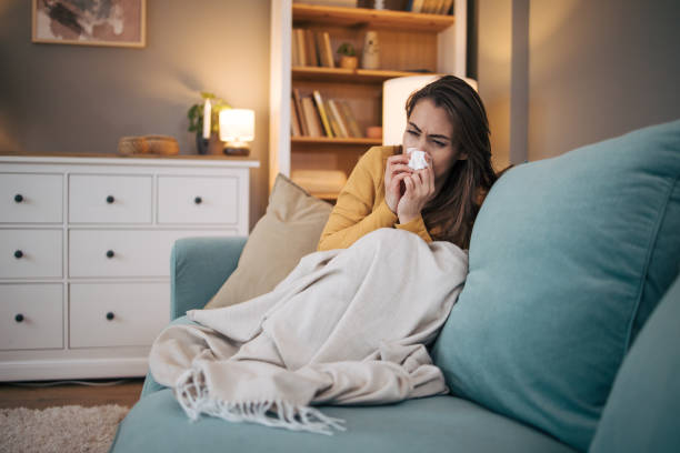 istock Sick woman sitting on sofa at home. 2075190679