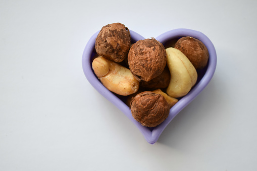 A heart-shaped bowl of assorted nuts