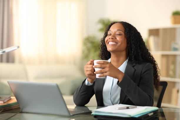 istock Happy black tele worker drinking and relaxing at home 2075229658