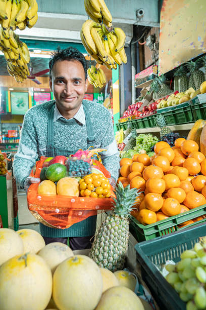 istock A shopkeeper sells various fresh fruits. 2075234586